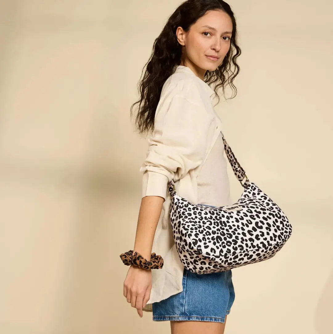 Noor leopard print shoulder bag worn crossbody over beige outfit